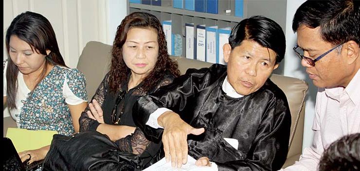 Sotheara Chhim, Executive Director of the Cambodian Transcultural Psychosocial Organization Cambodia (right), consults with visitors from Burma representing the Assistance Association for Political Prisoners and Social Action for Women.