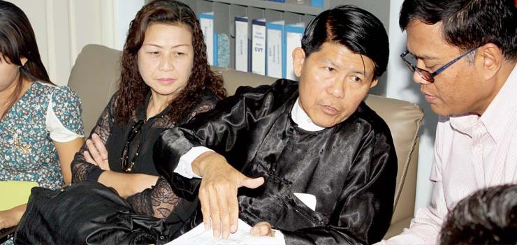 Sotheara Chhim, Executive Director of the Transcultural Psychosocial Organization Cambodia (right), consults with visitors Burma representives from the Assistance Association for Political Prisoners and Social Action for Women on mental health.