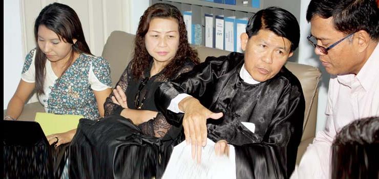 Sotheara Chhim, Executive Director of the Transcultural Psychosocial Organization Cambodia (right), consults with visitors Burma representives from the Assistance Association for Political Prisoners and Social Action for Women on mental health.